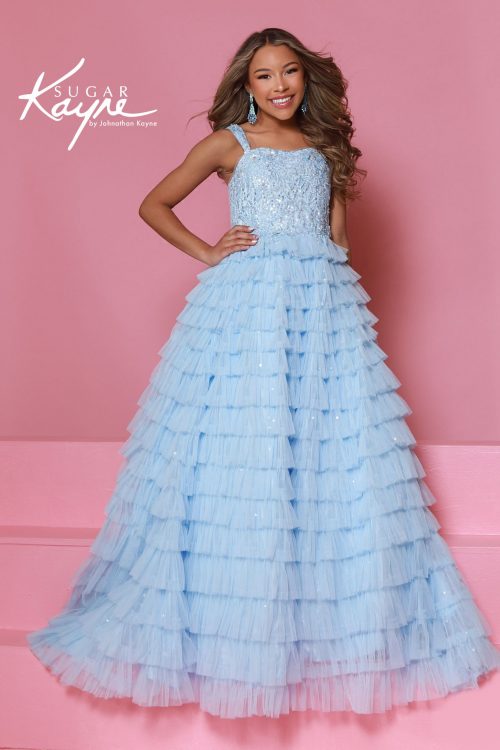A young girl wearing a light blue ruffle pageant gown with sequin bodice and tiered tulle skirt by sugar kayne.